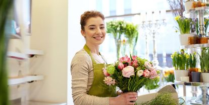 fleuriste avec un bouquet de fleurs dans les mains